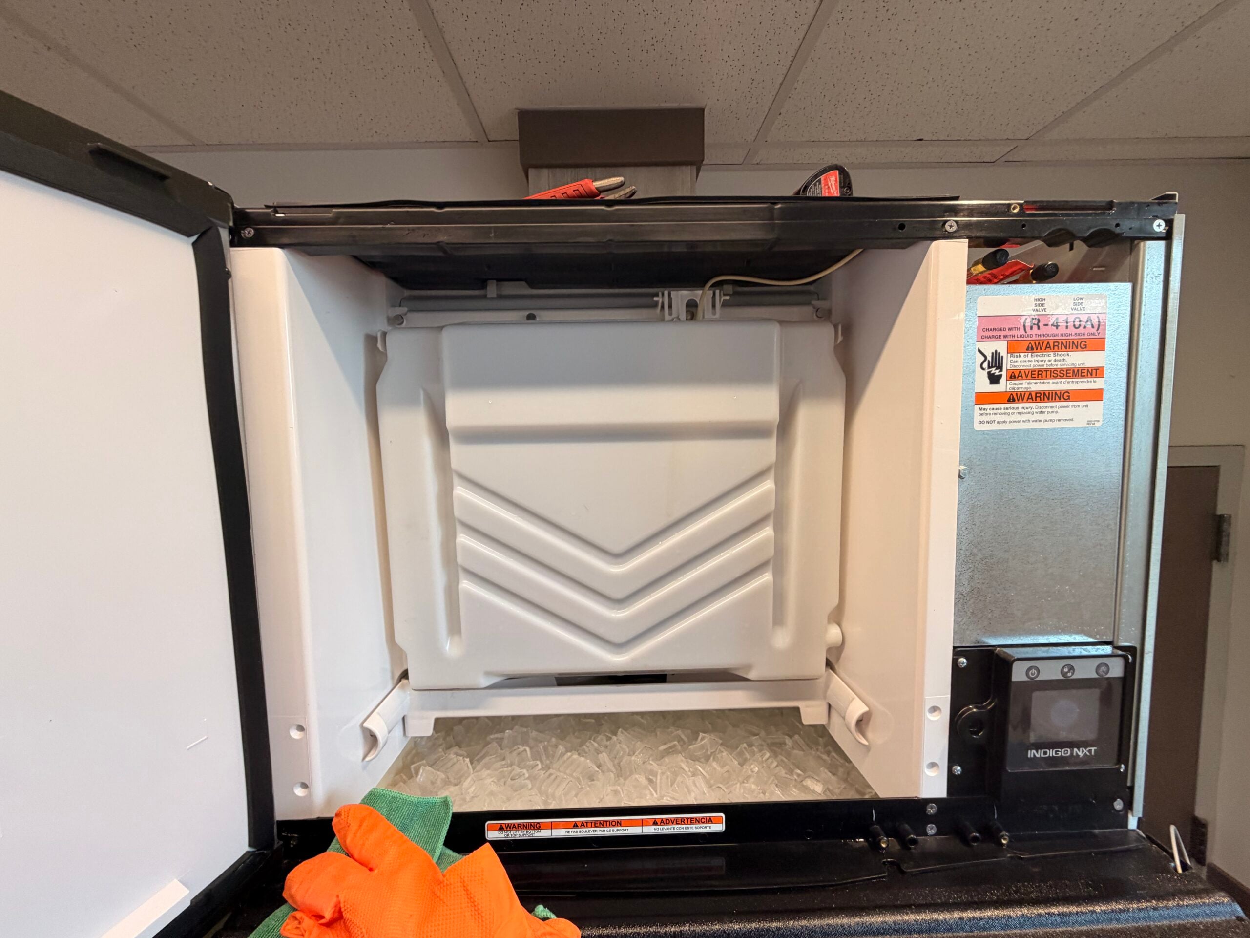 Technician cleaning and sanitizing a commercial ice machine