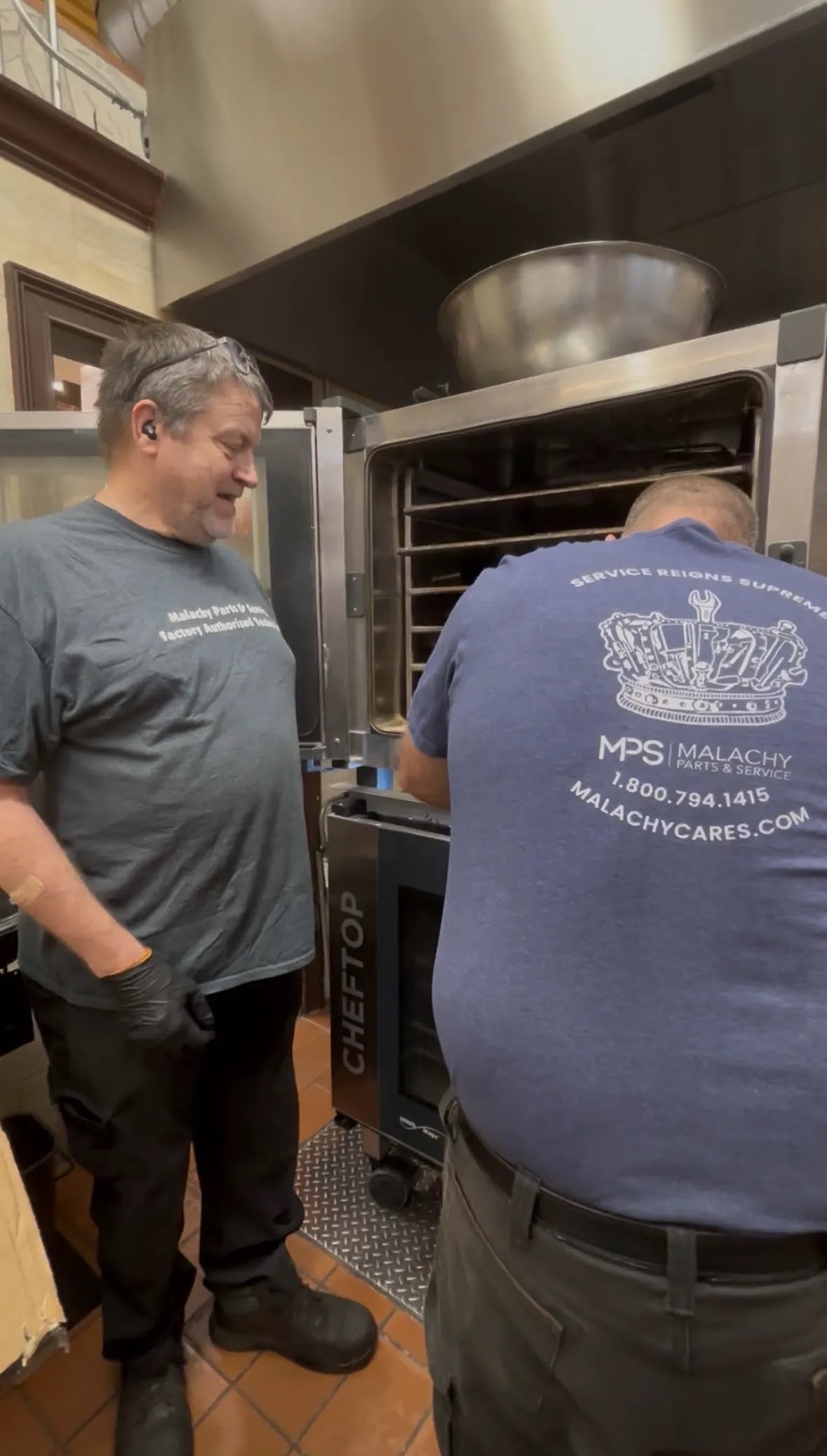 Technician servicing commercial kitchen equipment before the holiday rush