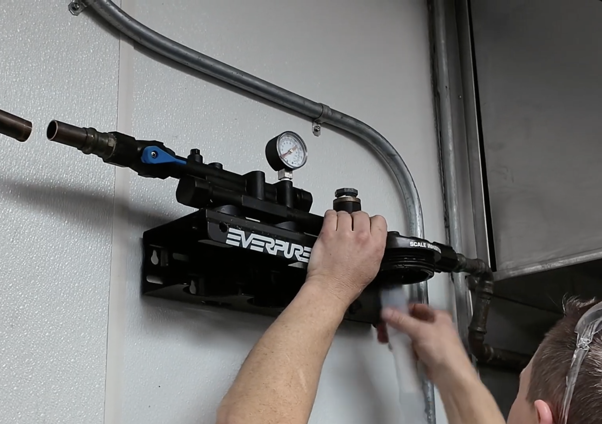 Malachy technician replacing a commercial water filtration cartridge