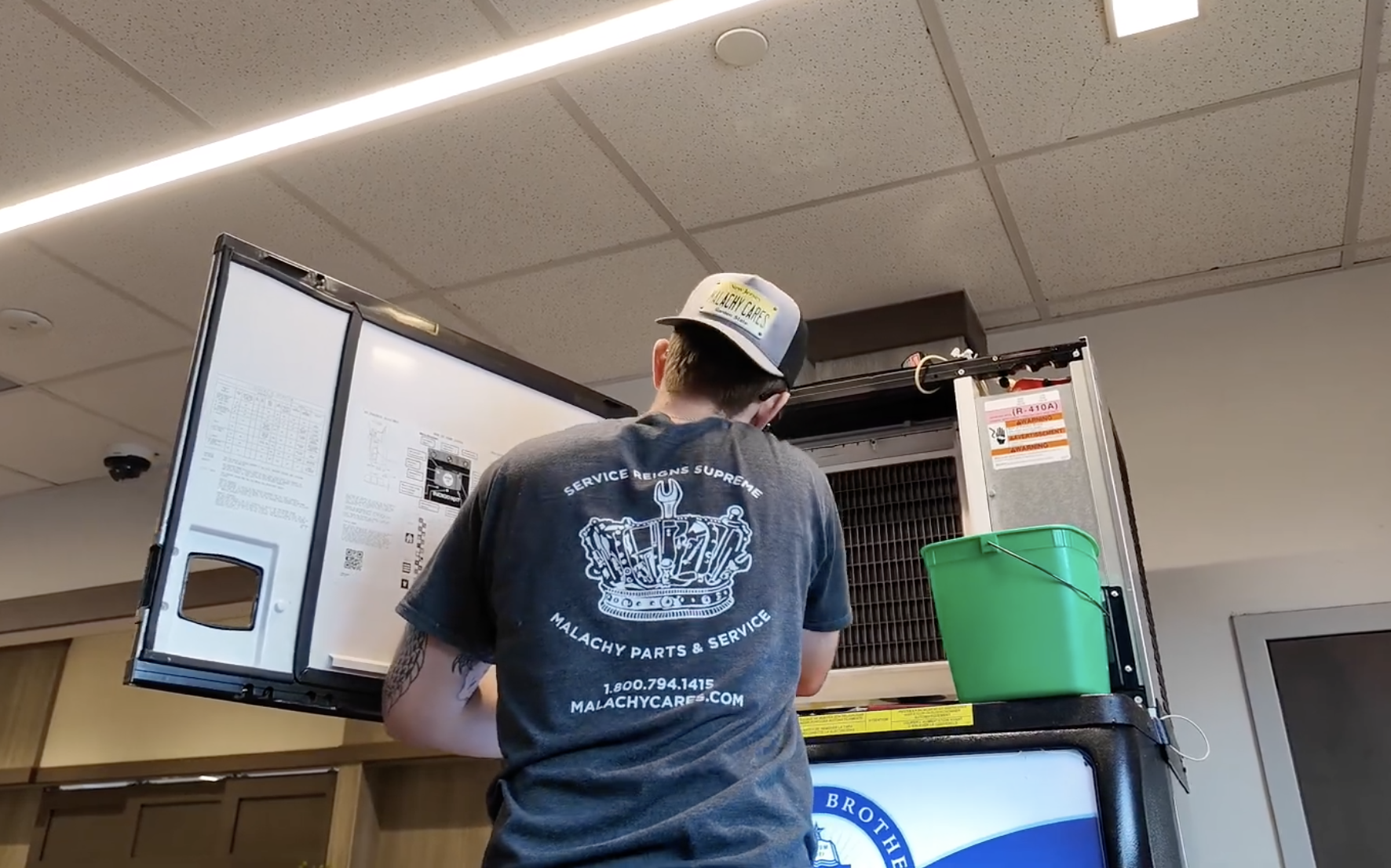 Malachy technician servicing a commercial ice machine in a restaurant kitchen
